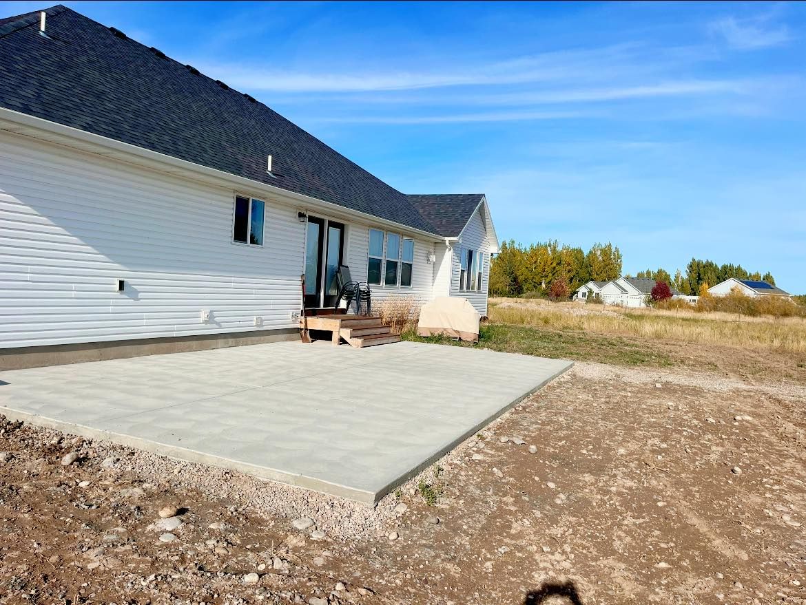 A white house with a concrete patio in front of it