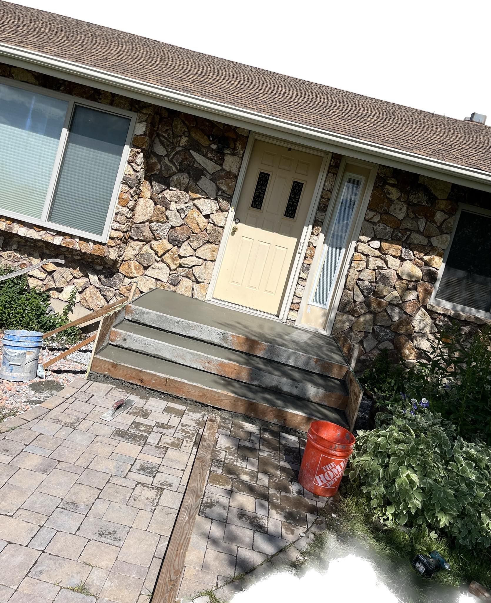 An aerial view of a house with stairs leading up to the front door