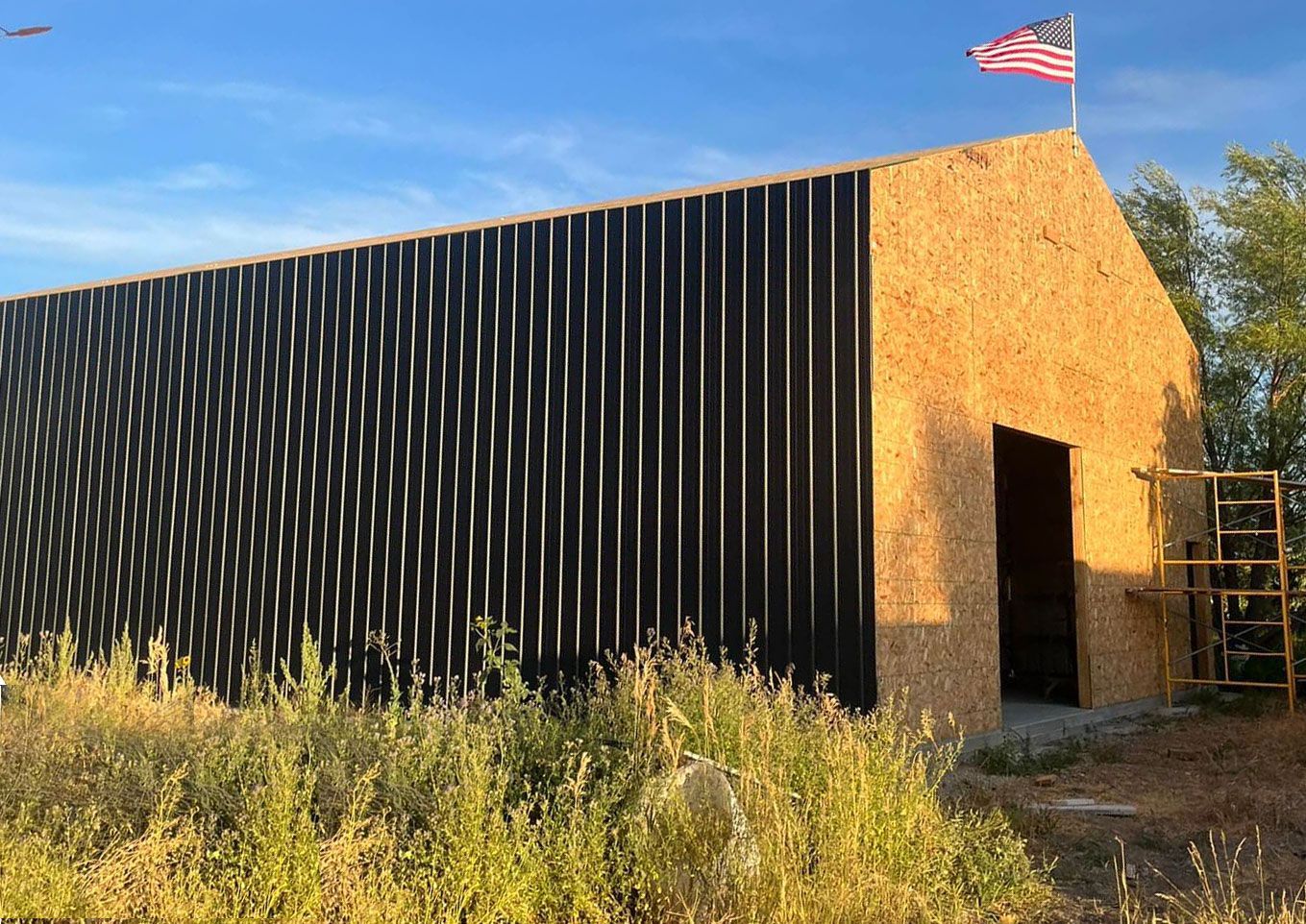 A building with a flag on top of it is sitting on top of a hill