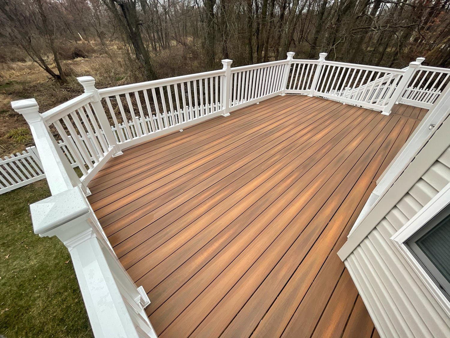 An aerial view of a wooden deck with a white railing