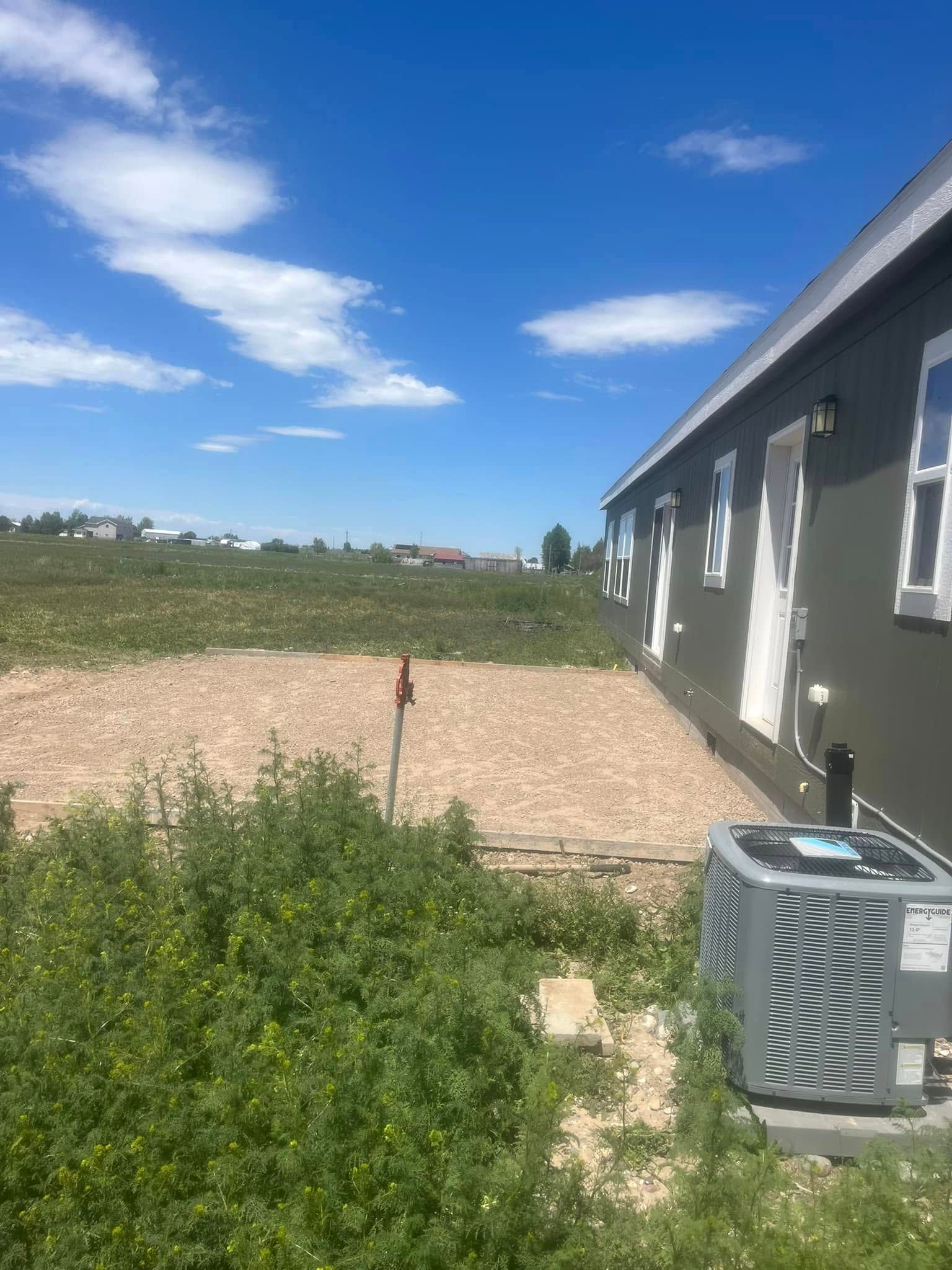 A house with a lot of grass and a lawn in front of it
