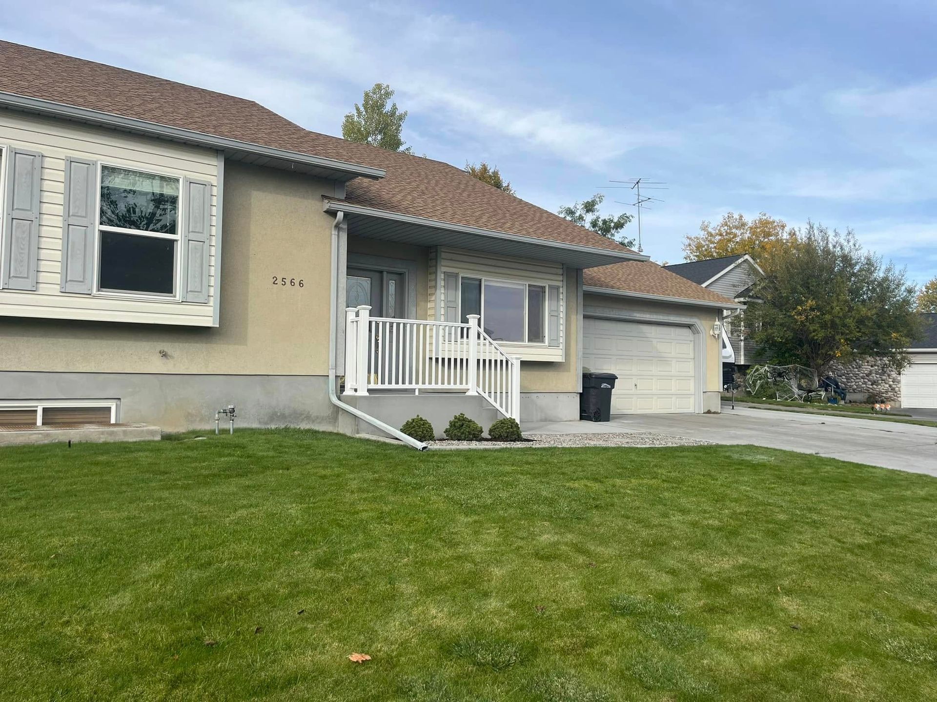 A house with a large lawn in front of it