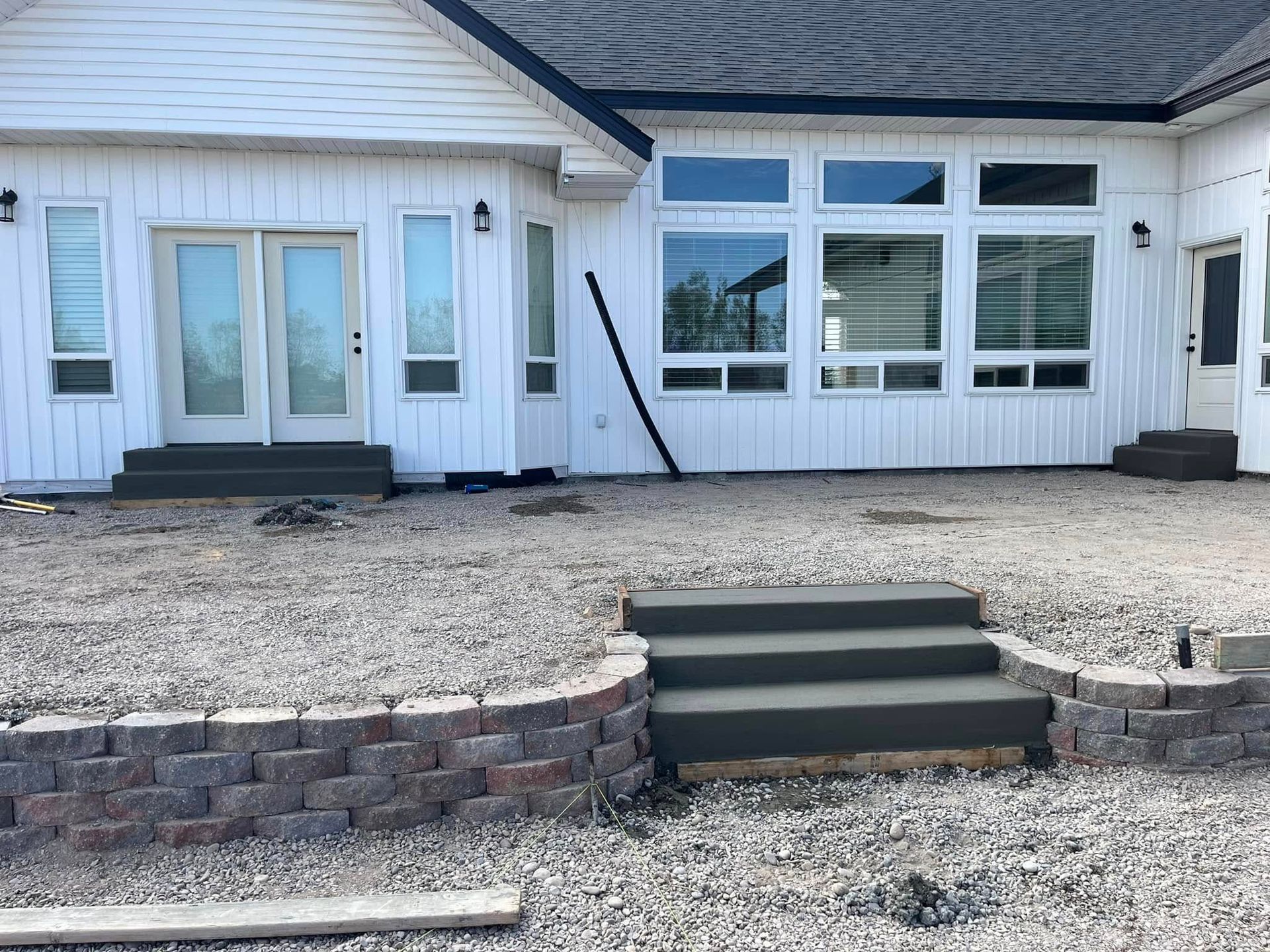 A white house with concrete steps in front of it