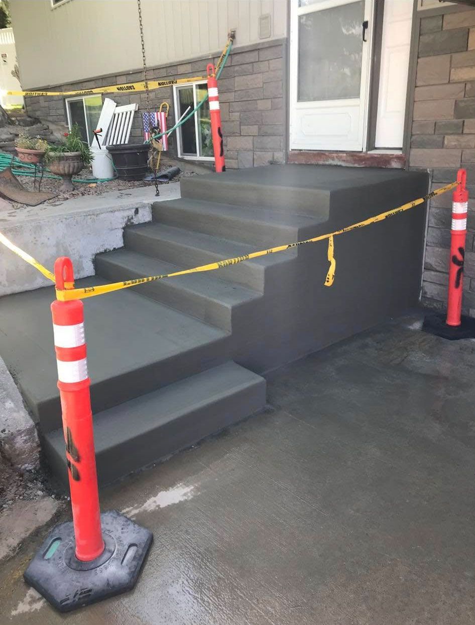 A concrete staircase is being built in front of a house