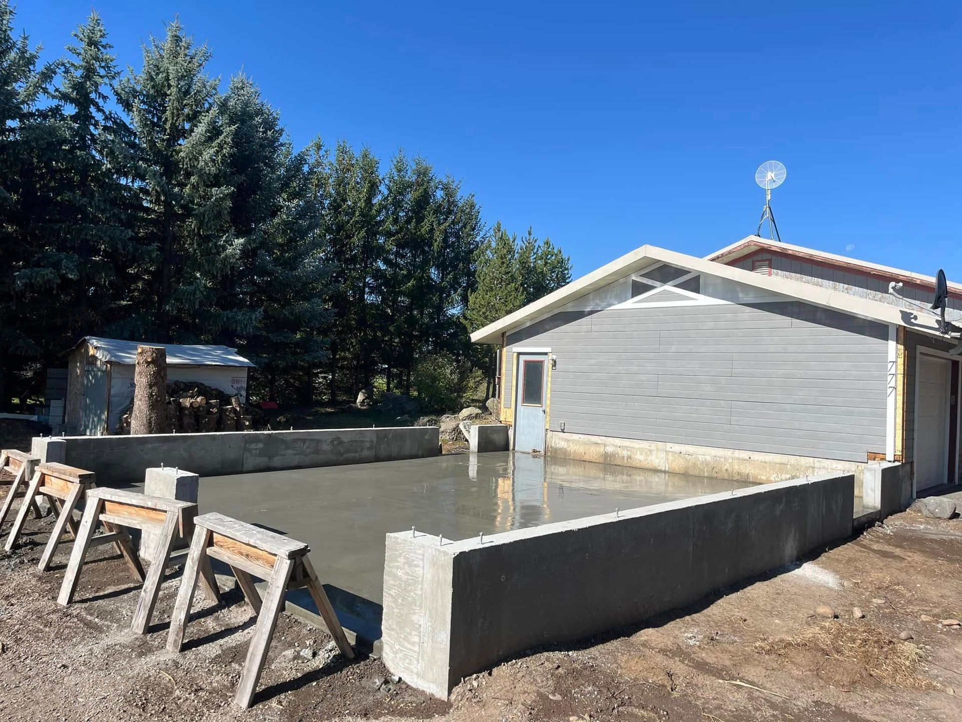 A house is being built with a concrete slab in front of it
