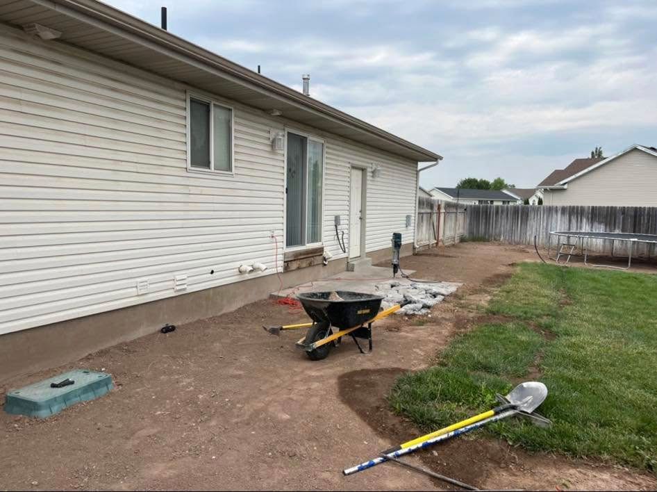 A house with a wheelbarrow and shovel in front of it