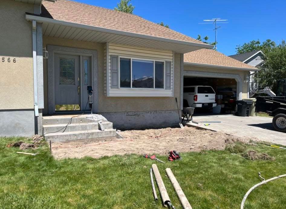A house with a truck parked in front of it is being remodeled