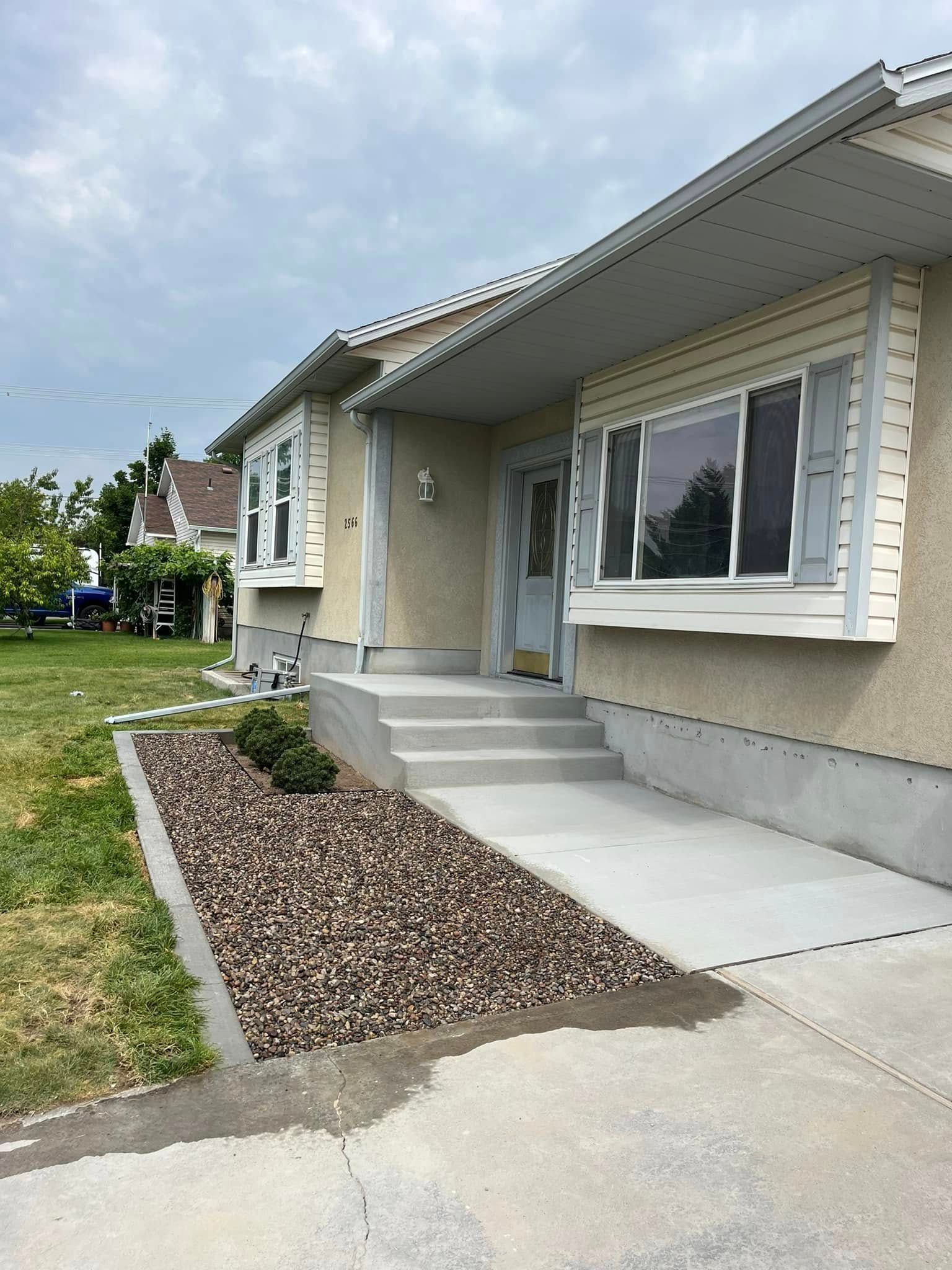A house with a concrete walkway leading to the front door