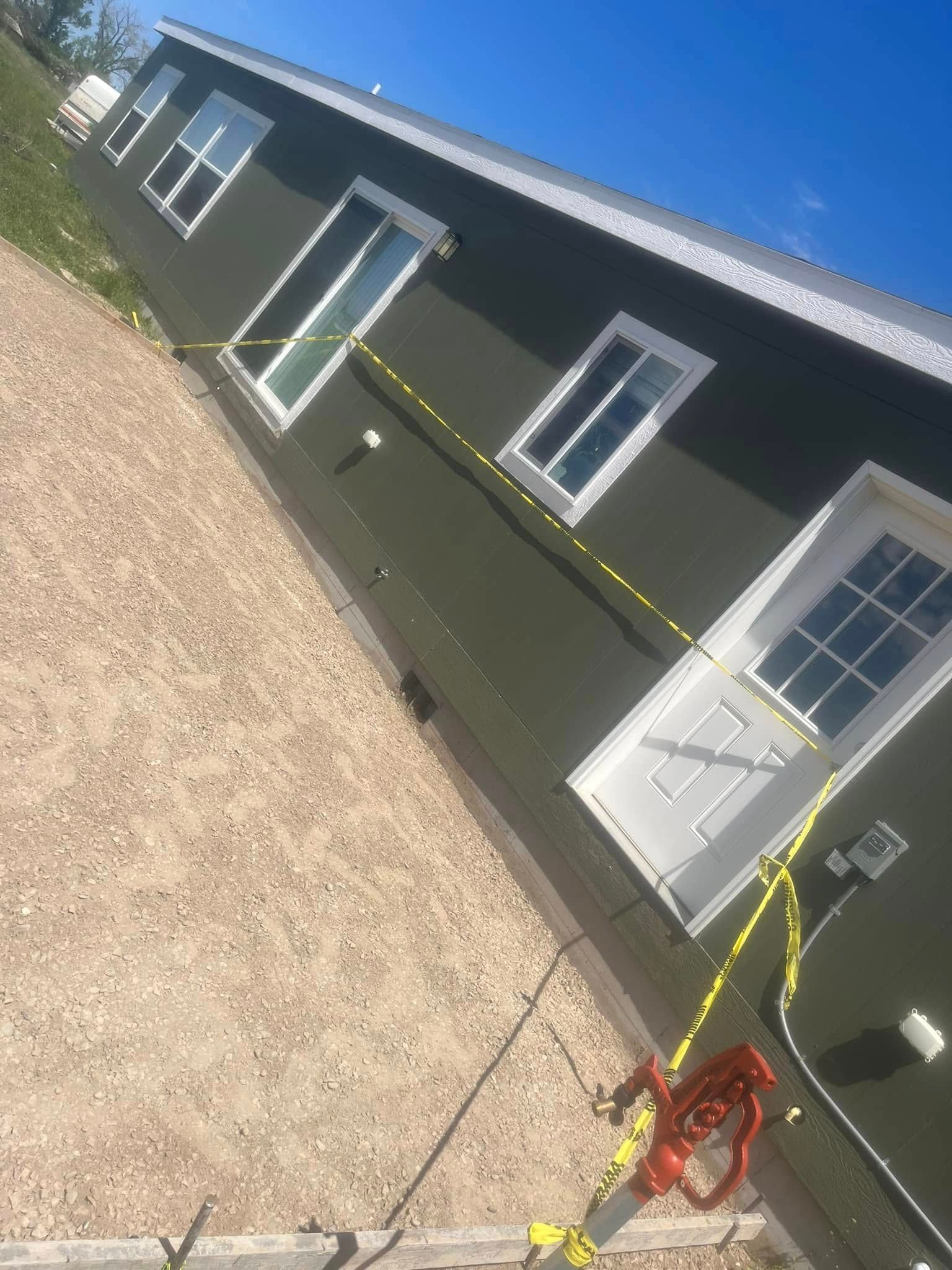 A house with a lot of windows and doors is being built