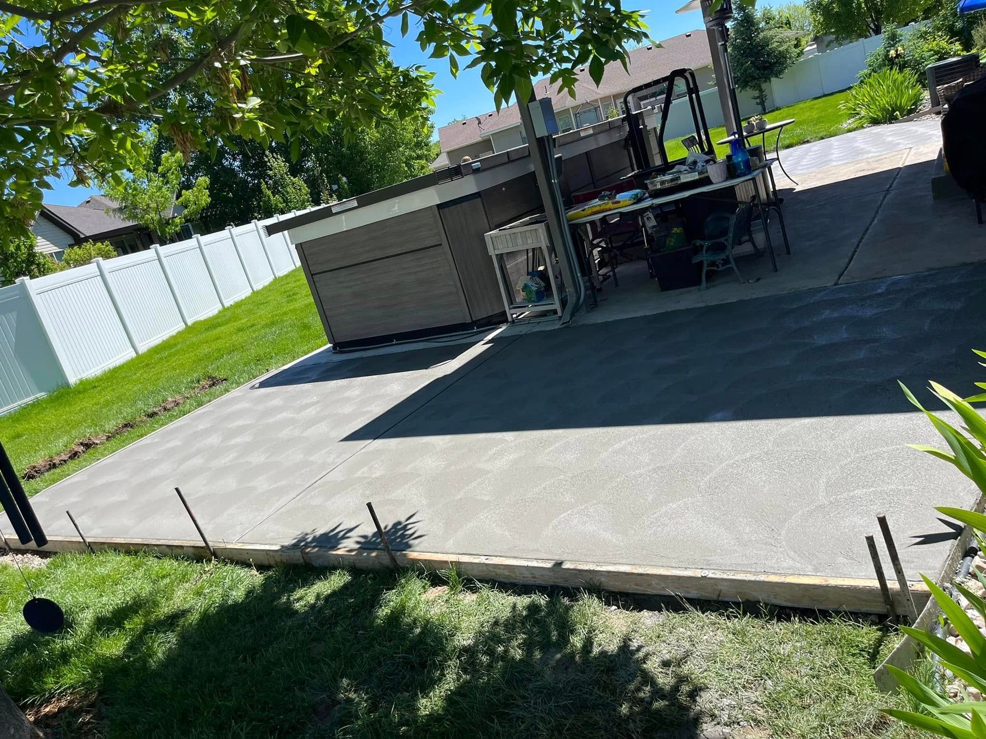 A concrete driveway is being built in a backyard