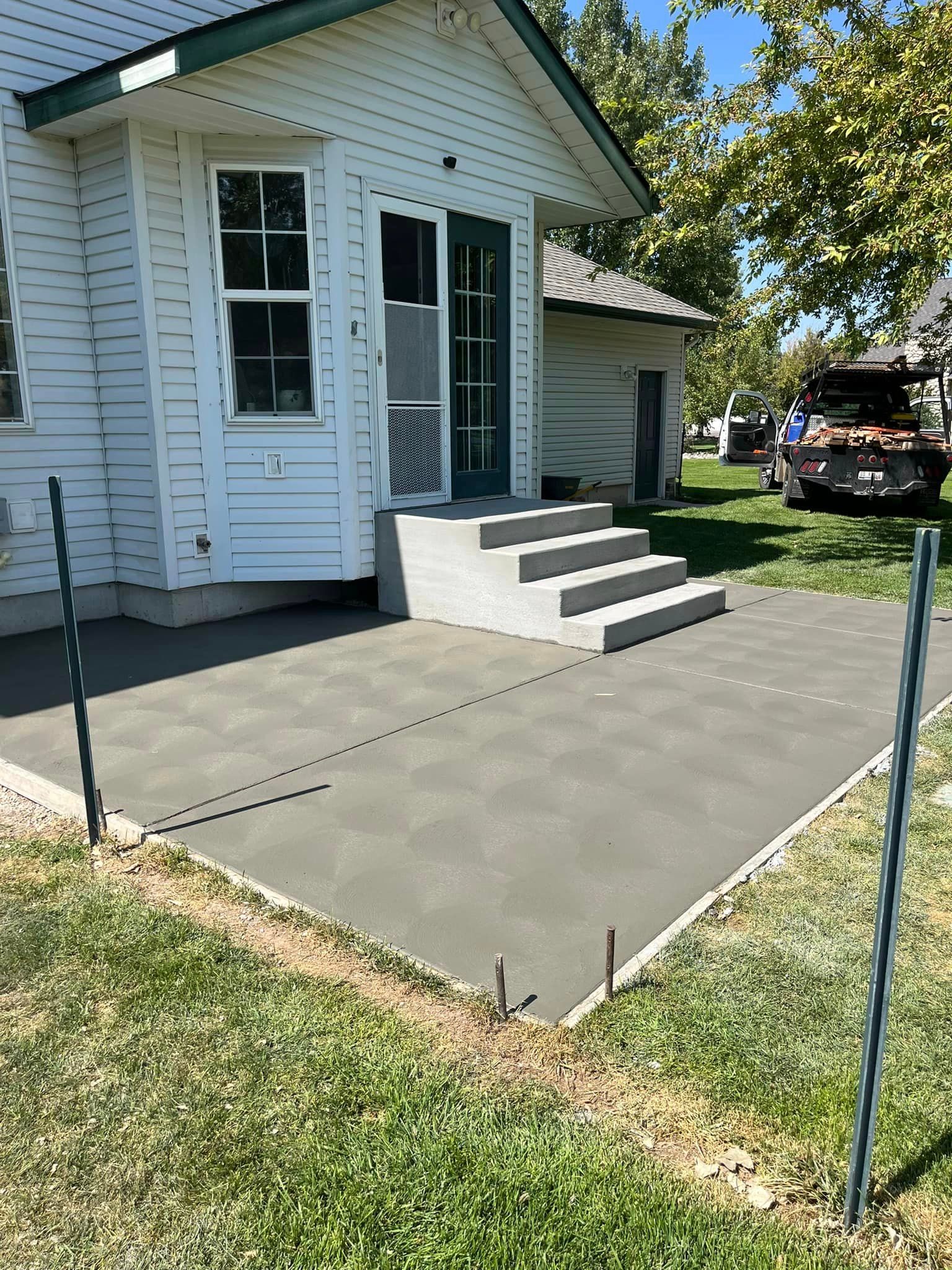 There is snow on the ground and a concrete wall in the background.