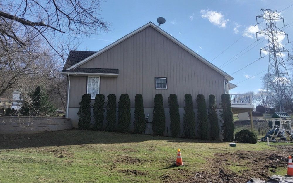 After-house verical tan siding