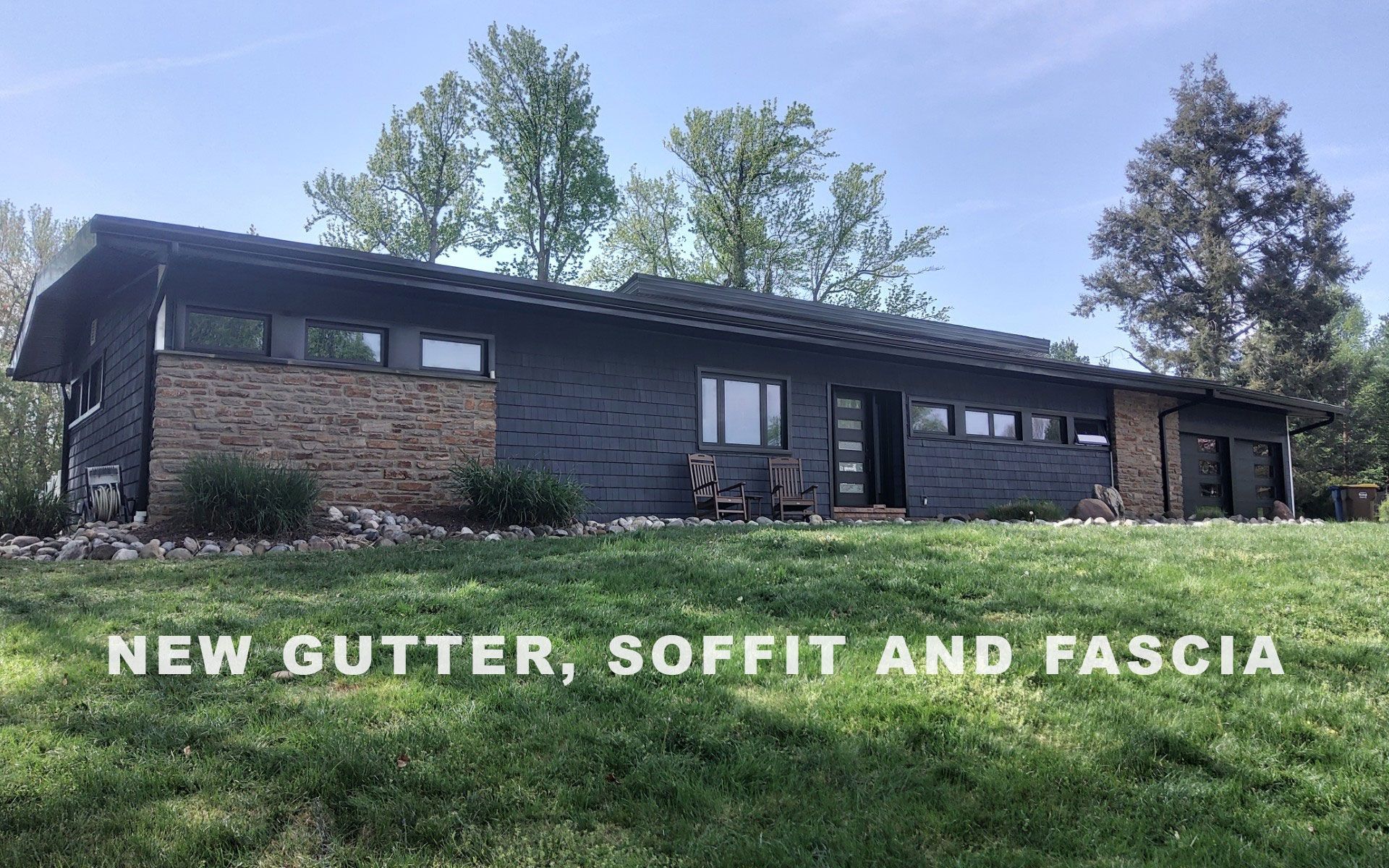 Brick house with new gutter, soffit, and fascia installed along the roofline
