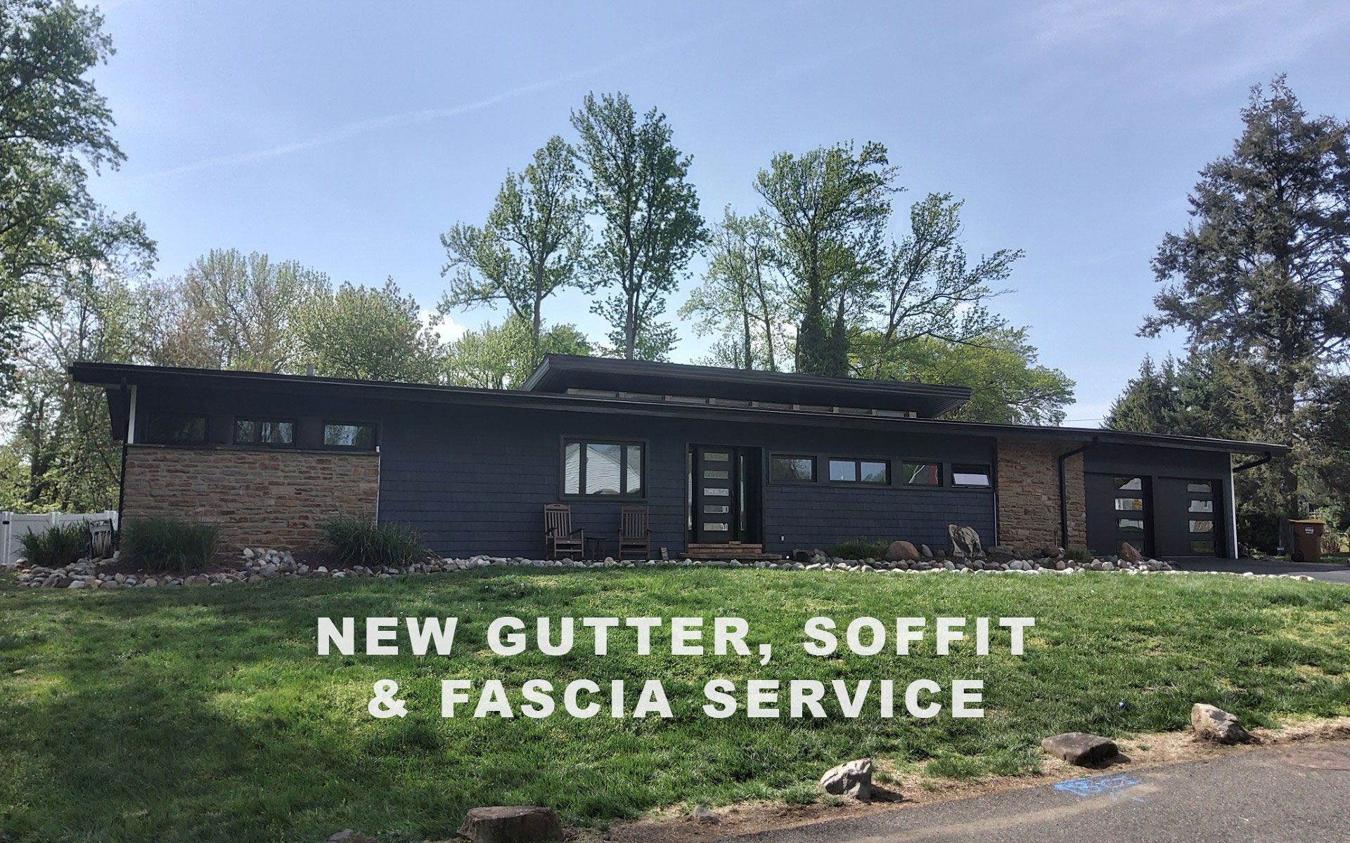 Brick ranch house with text advertising new gutter, soffit, and fascia service