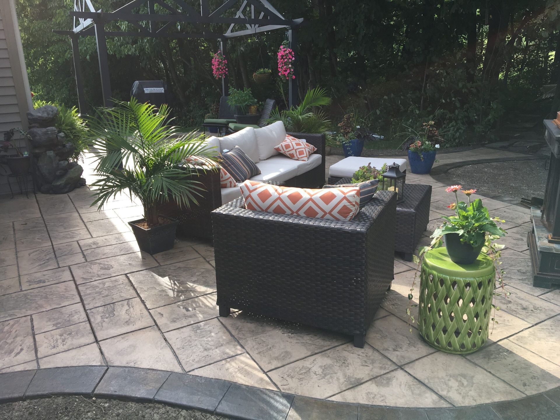 Outdoor patio with seating, plants, and a pergola.