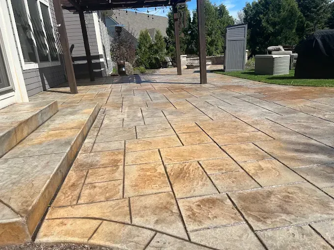 Stamped concrete patio with varying shades of tan, brown, and gray.
