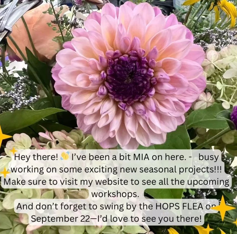 A close up of a pink flower with a purple center