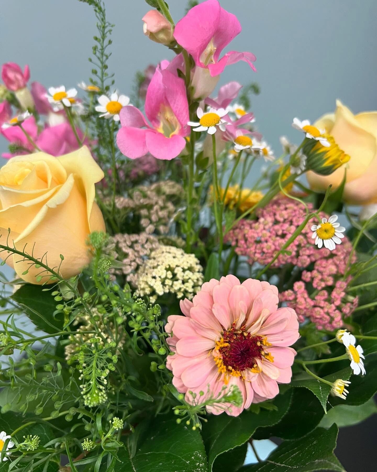 A close up of a bouquet of pink and yellow flowers