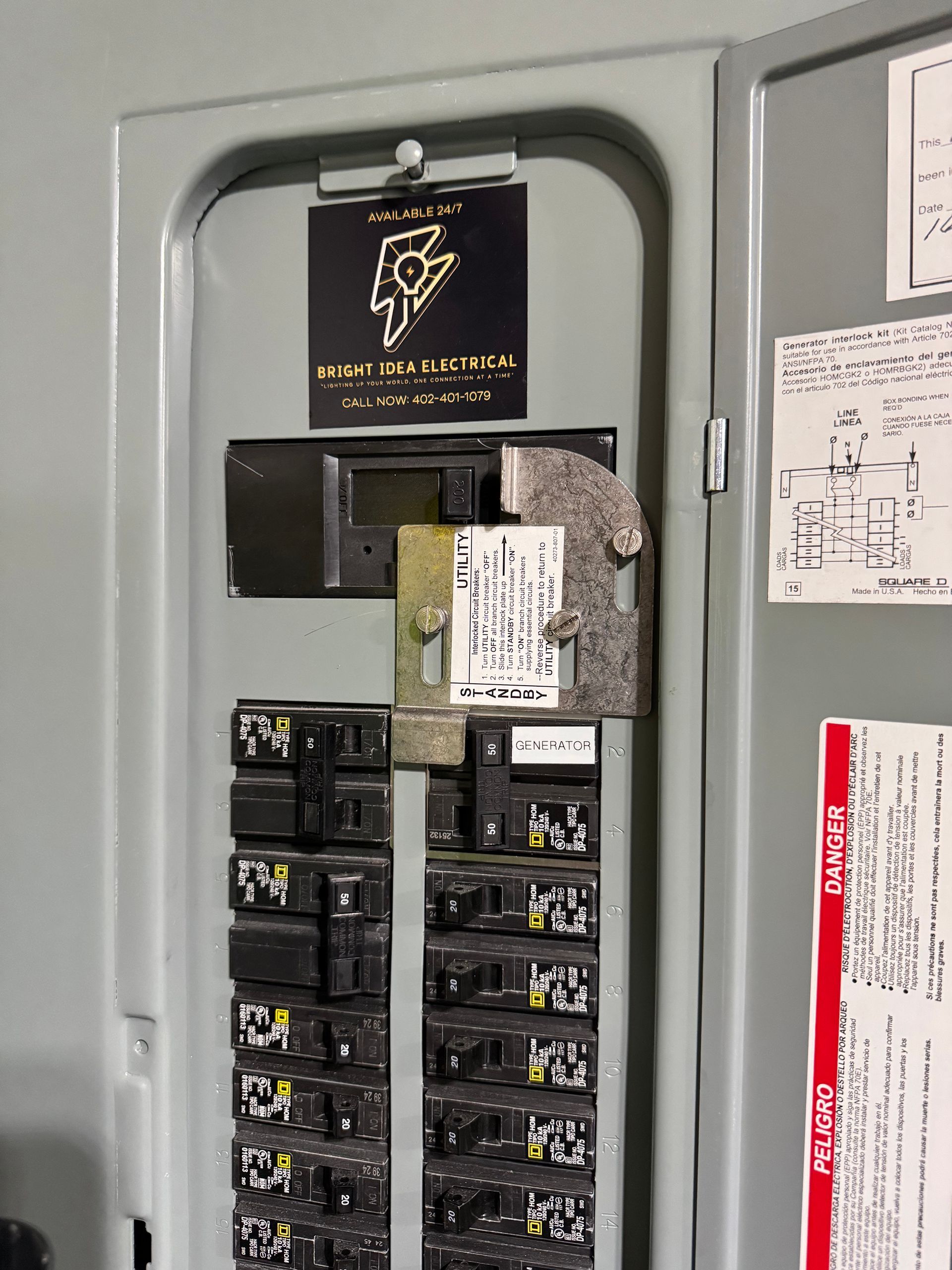 Electrical panel with circuit breakers, label, and warning sign.