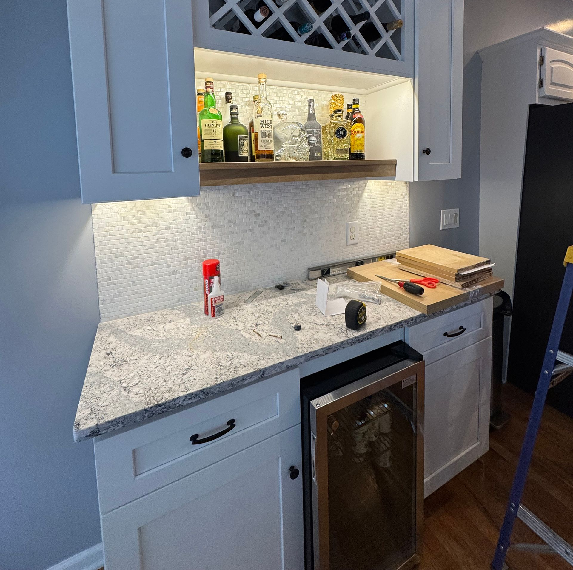 Ceiling with ventilation, recessed lights, and a bedroom setting with a bed and armchair.