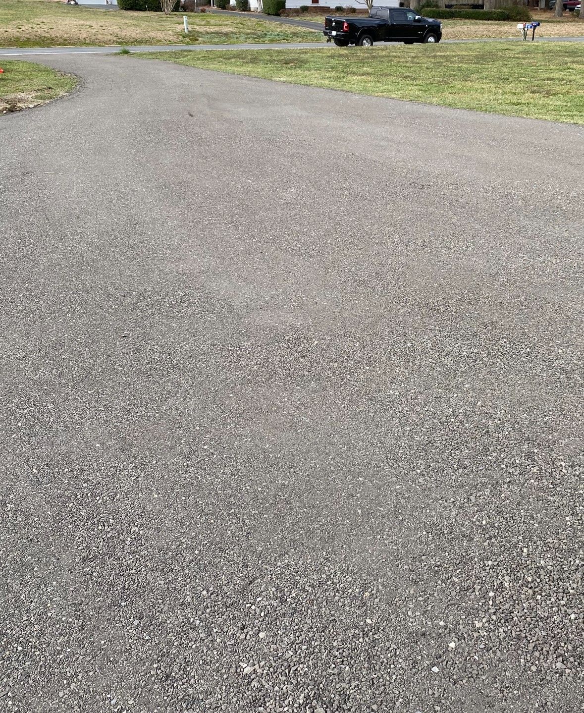 A black truck is parked on the side of a road