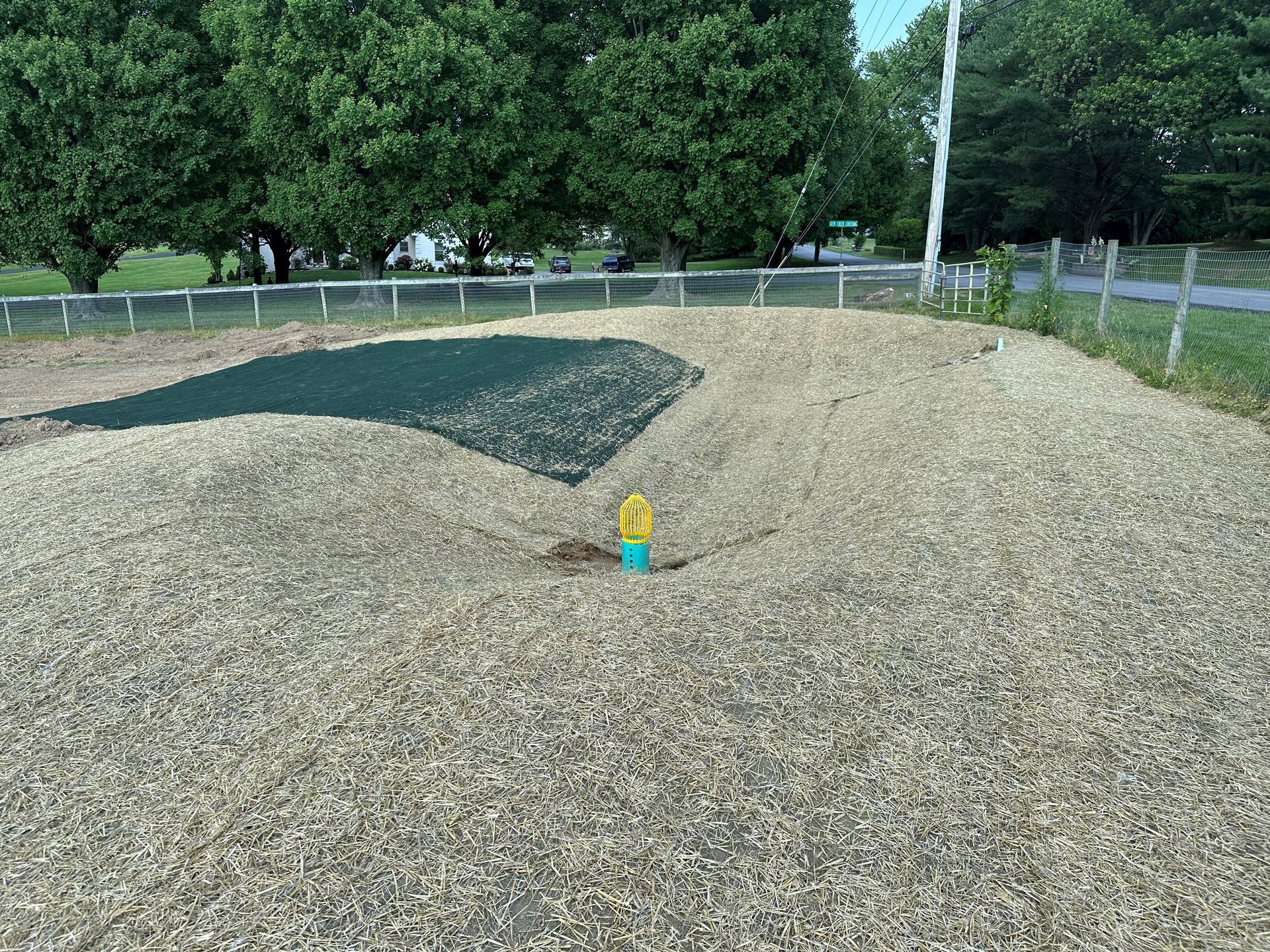 A pile of gravel is sitting on top of a dirt field