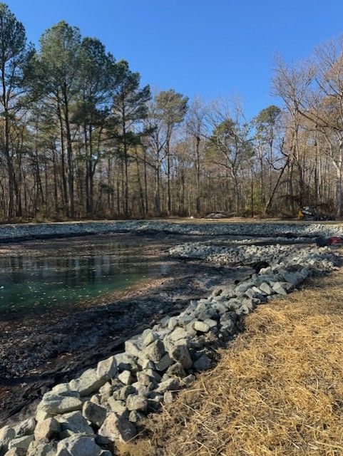 A body of water surrounded by rocks and trees