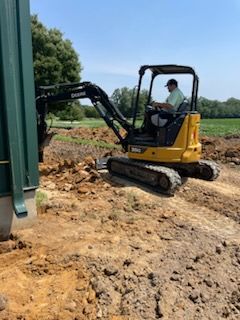 man on equipment doing grading services