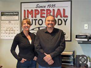 Adam Pellecchia and a woman standing in front of a sign that says imperial auto body