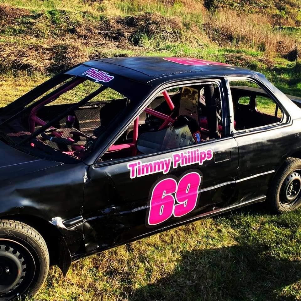 Black race car with pink accents, number 69. 