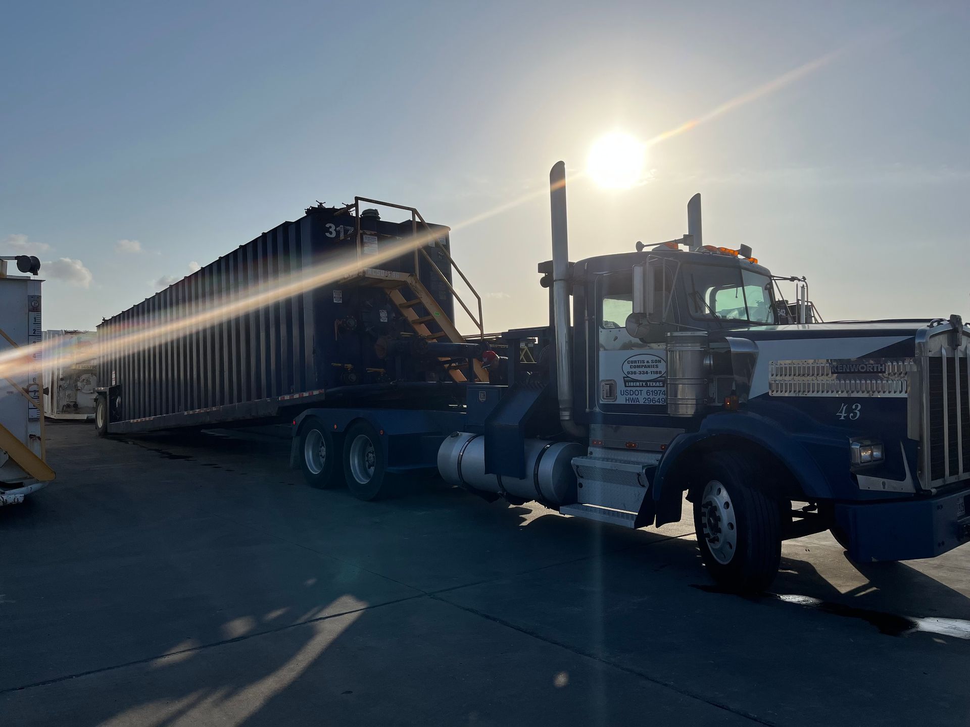 A semi truck is towing a train in a parking lot.