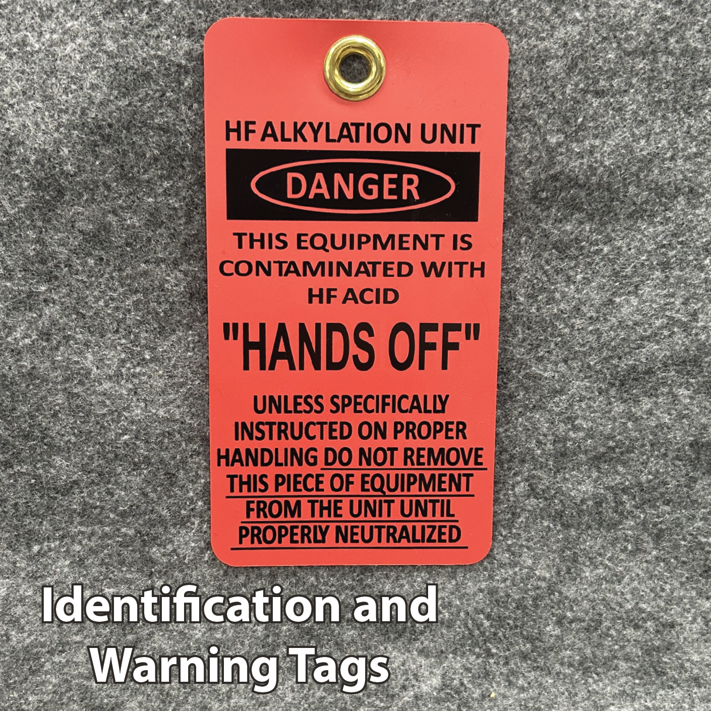 Red warning tag reading HF Alkylation Unit, DANGER, and HANDS OFF, warning of acid contamination