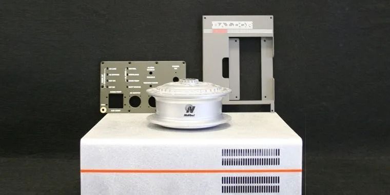 Several machine parts and components on a white box.