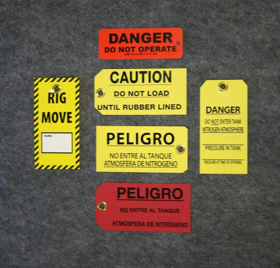 Collection of various colored danger and caution tags with warnings.