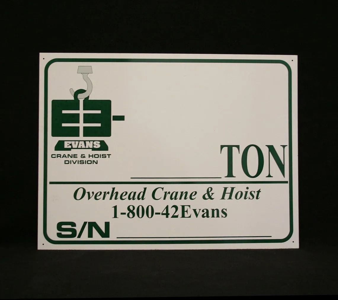 White sign with green lettering and logo for 