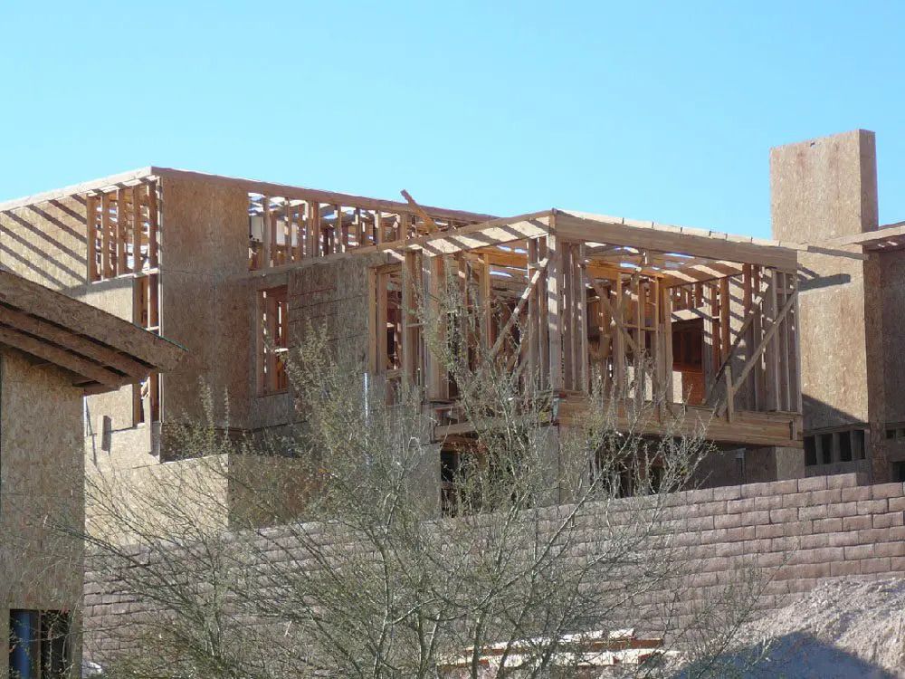 A house that is being built with a blue sky in the background