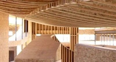 The inside of a building under construction with wooden beams.