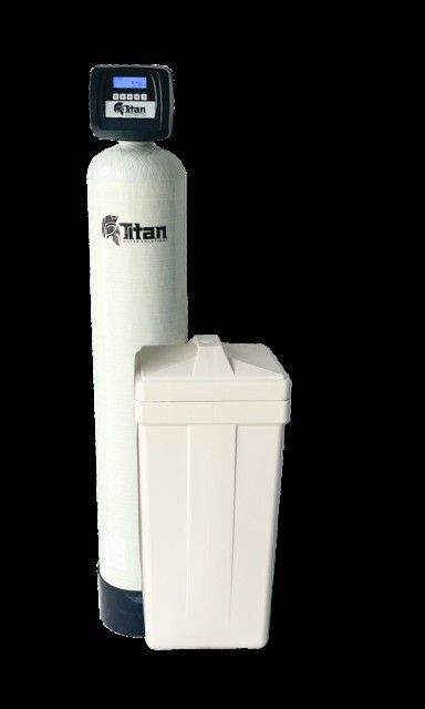 White Titan water softener system with a tall tank and salt storage unit, isolated on black background.
