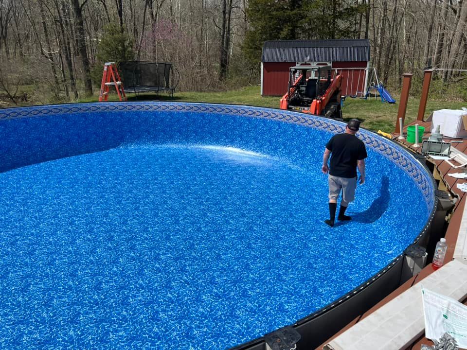 A man is standing in the middle of a swimming pool.