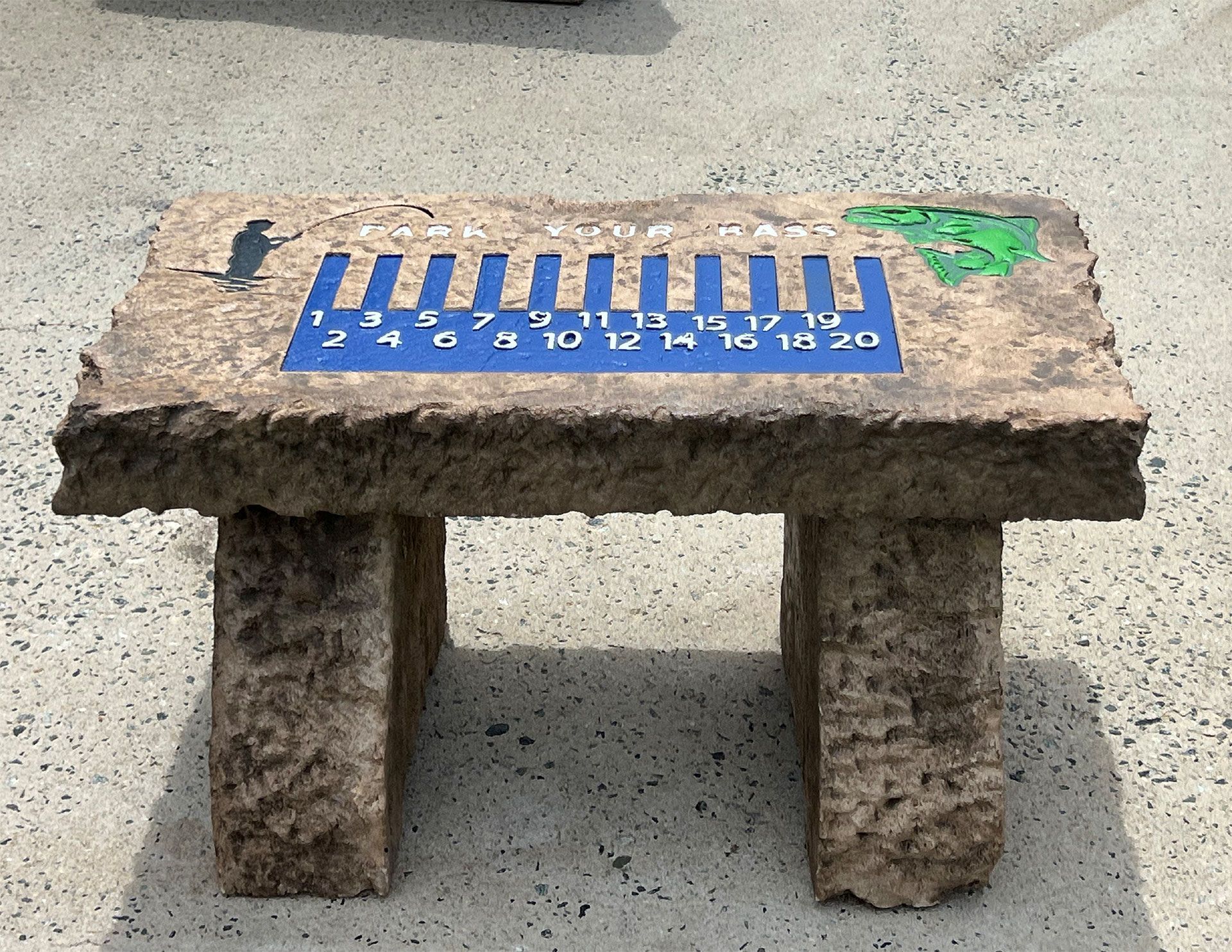 A small stone bench with a blue sticker on it that says ' clock '