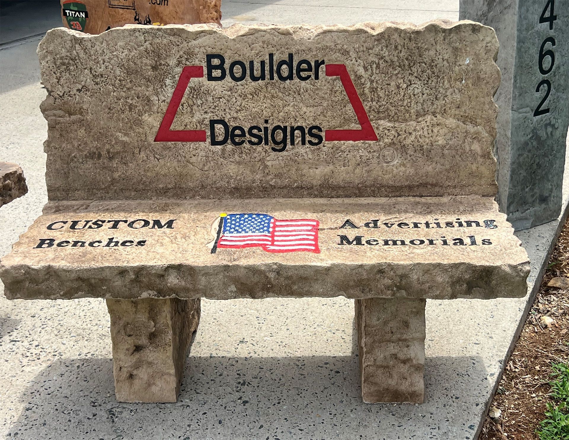 A stone bench with the words boulder designs on it