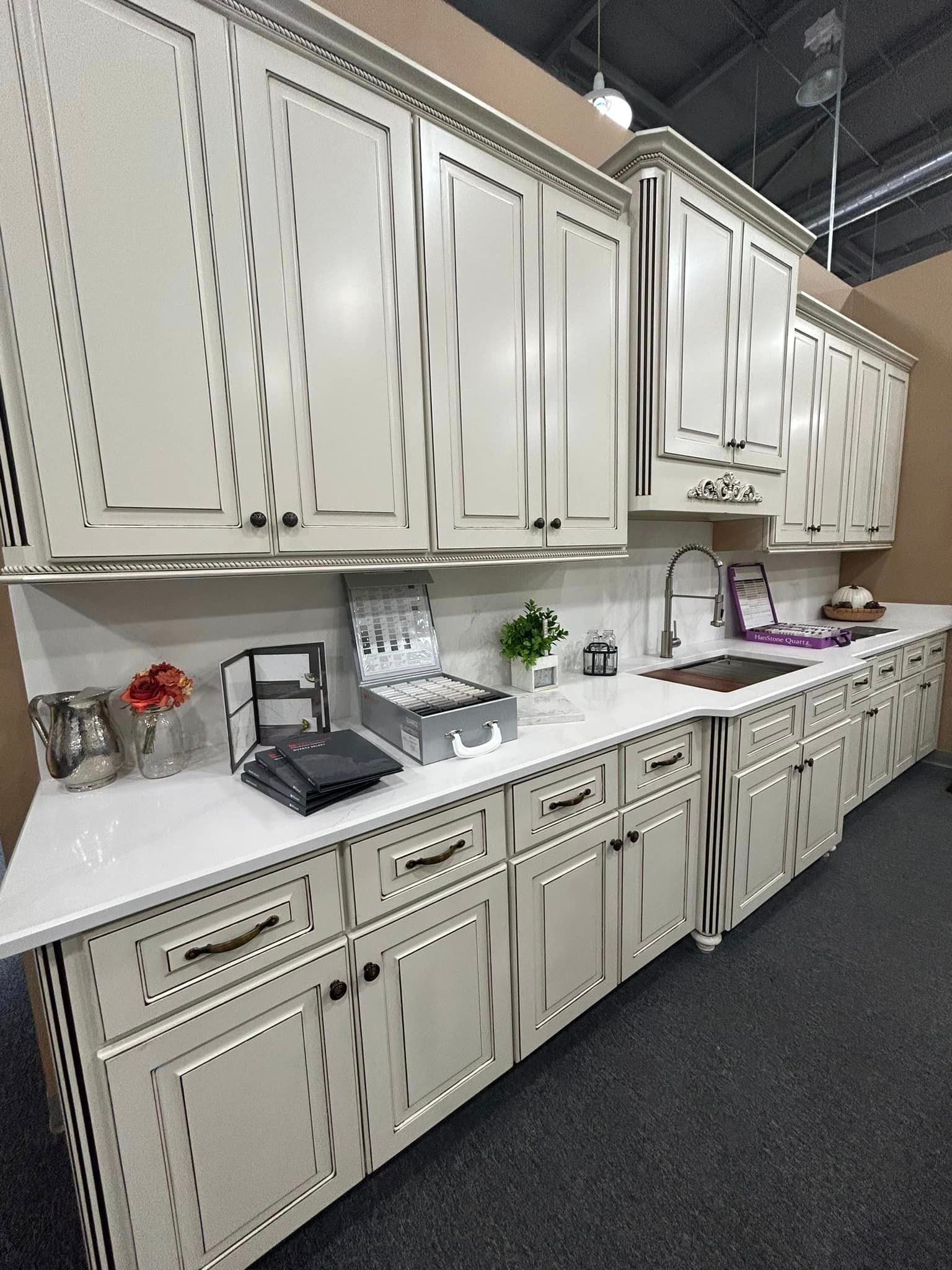 A kitchen with white cabinets and white counter tops