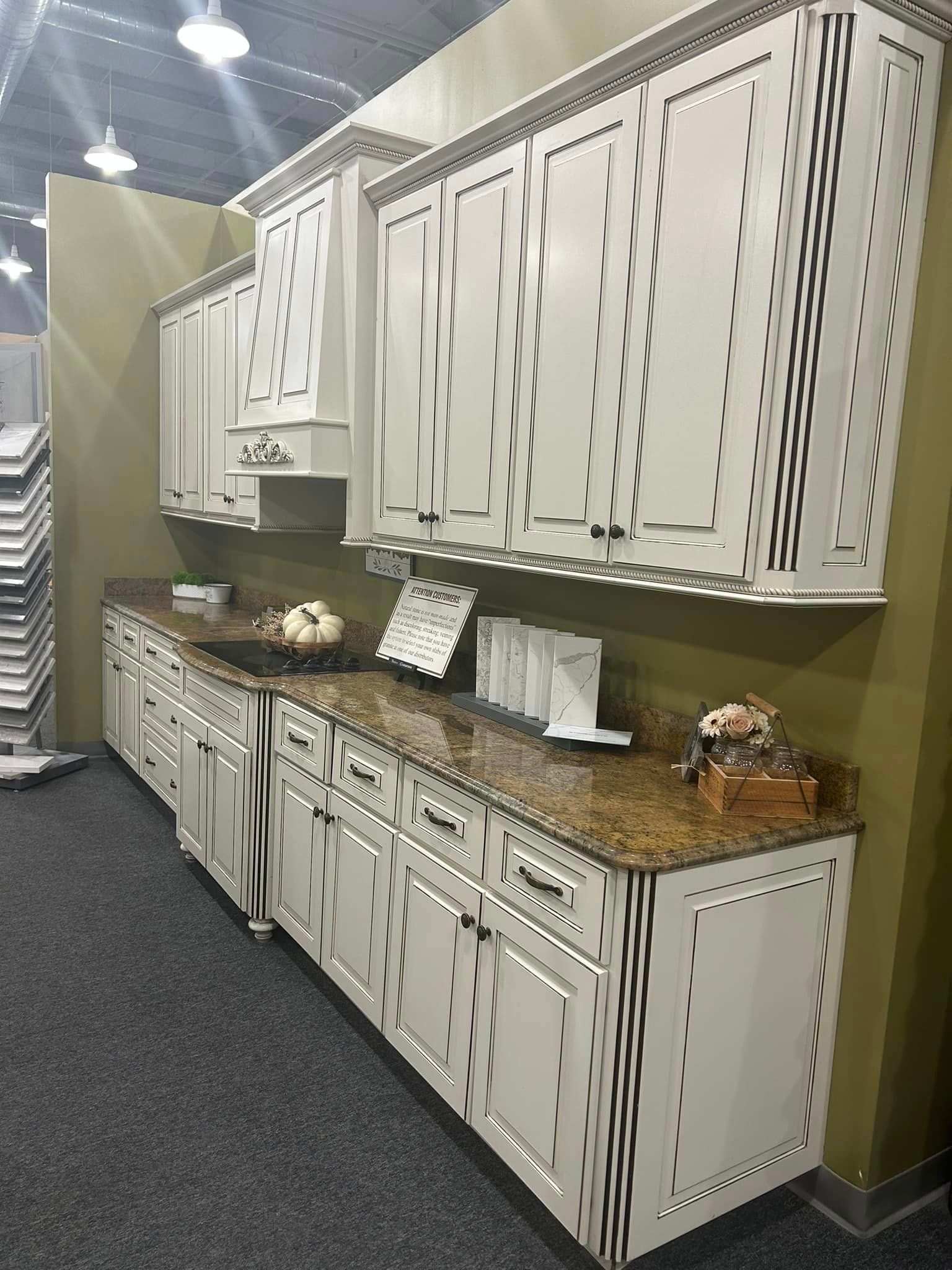 A kitchen with white cabinets and granite counter tops