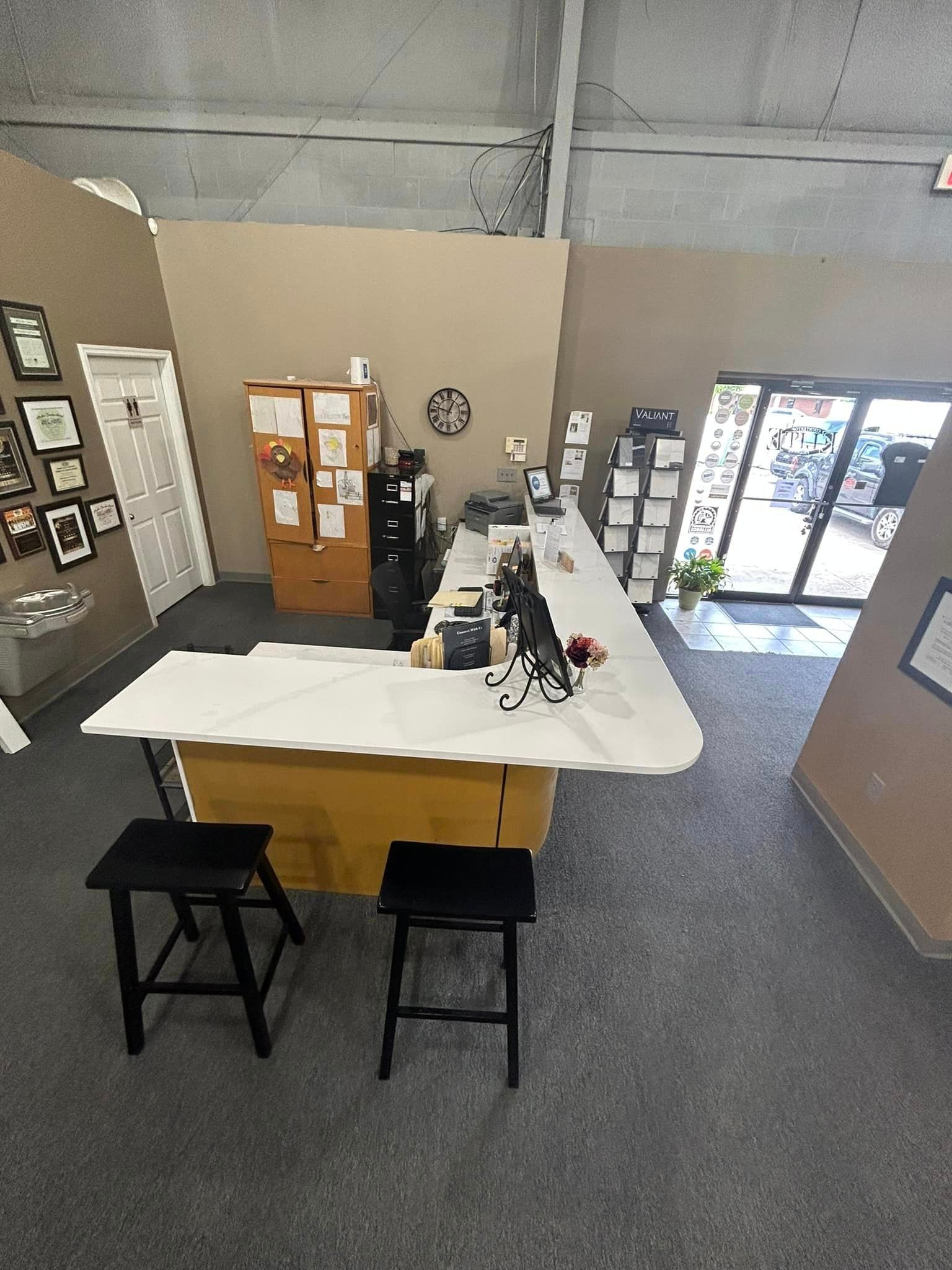An aerial view of a room with a table and stools.