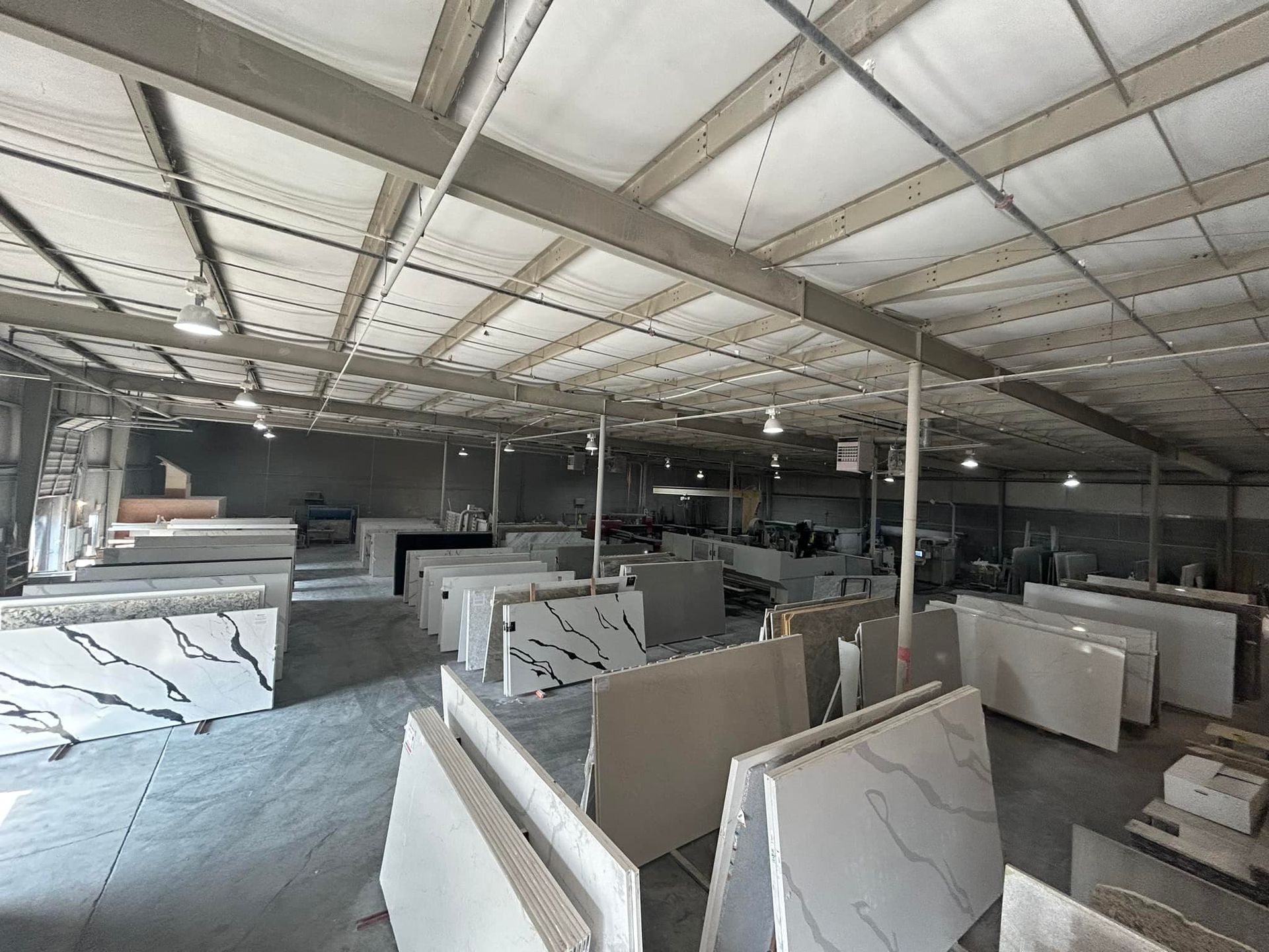 A large warehouse filled with lots of marble slabs.