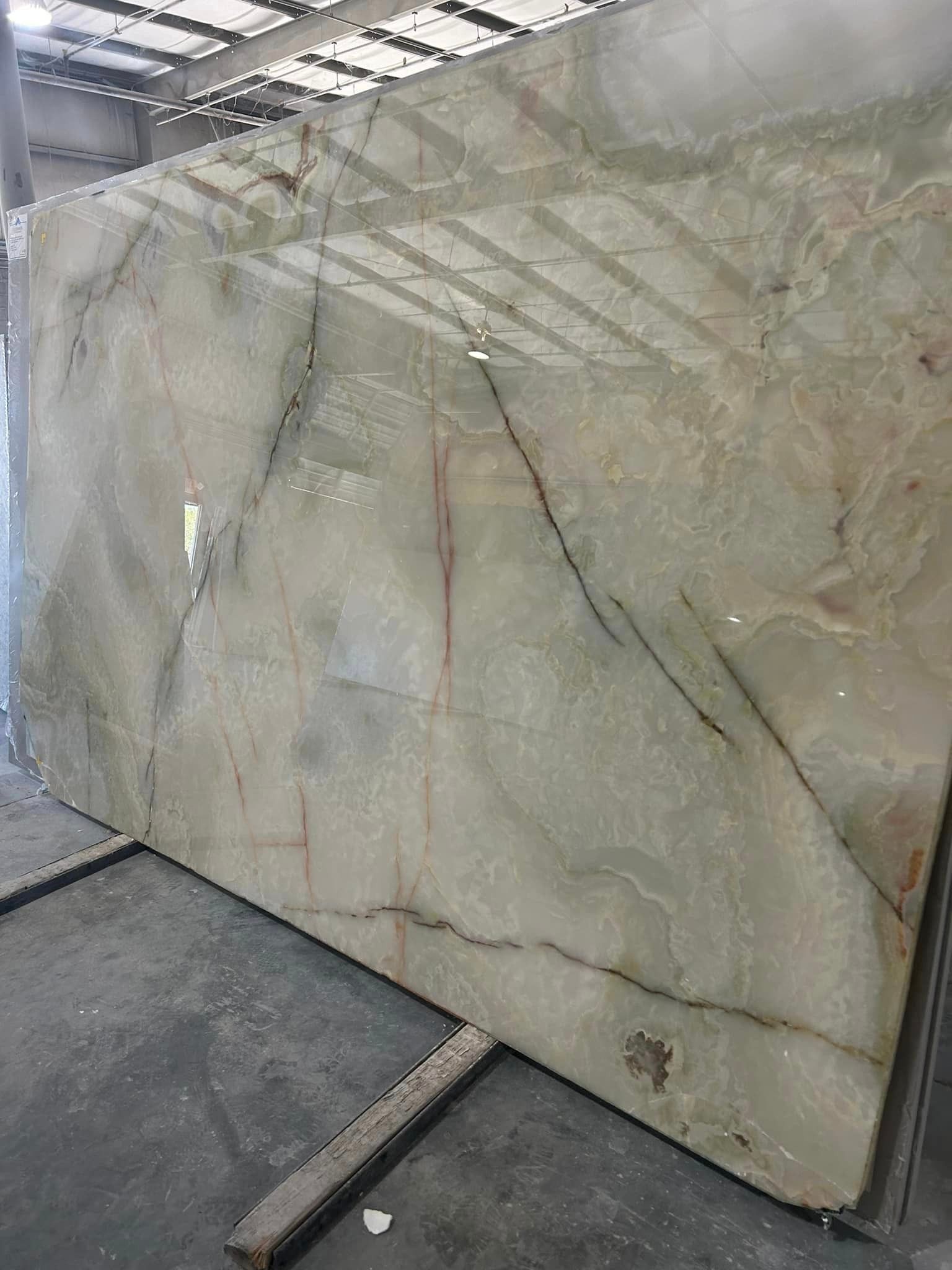 A large slab of marble is sitting on top of a concrete floor.