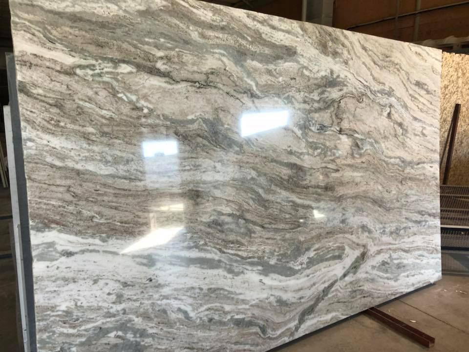 A large slab of granite is sitting on top of a wooden table.