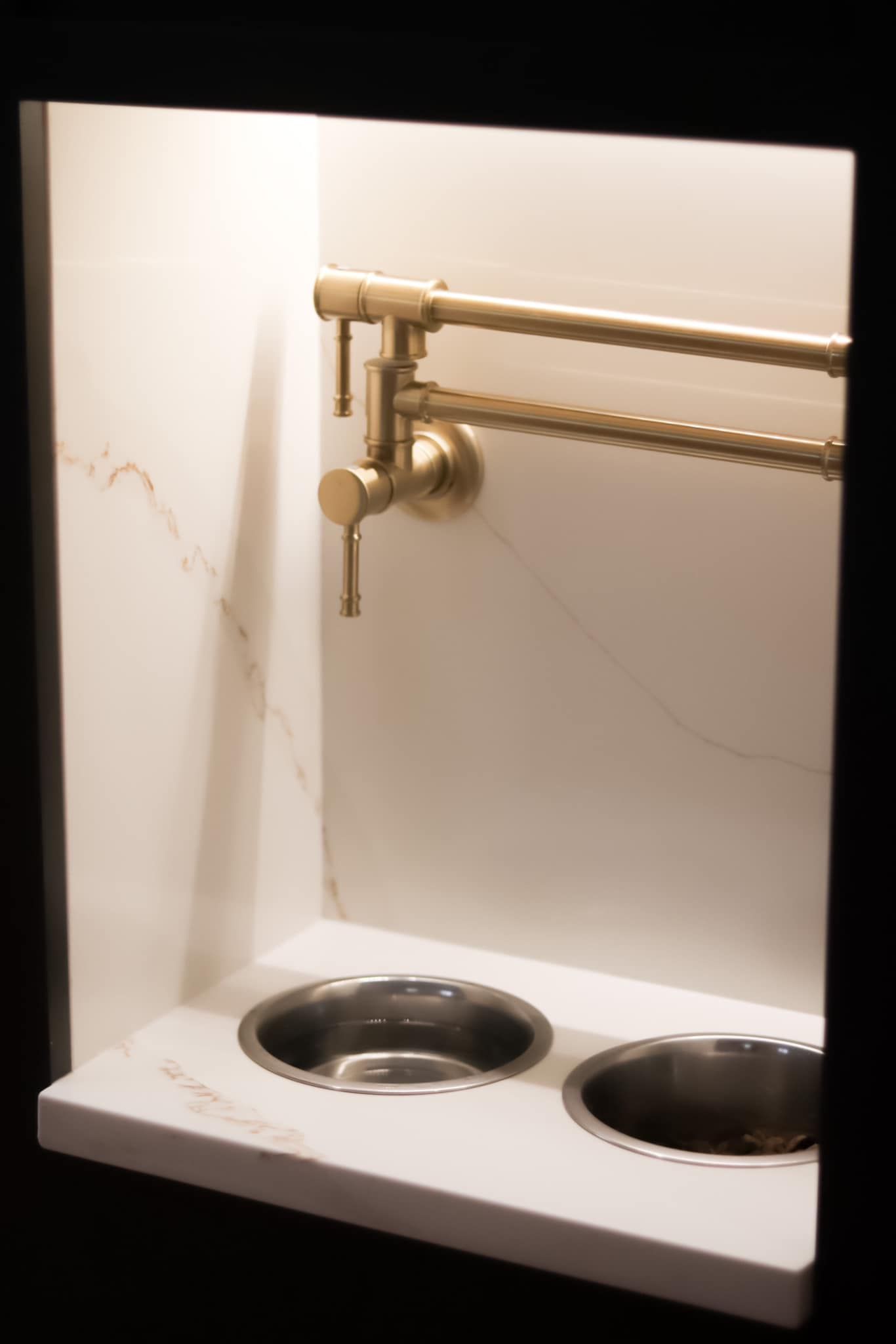 A kitchen sink with two stainless steel bowls and a faucet.