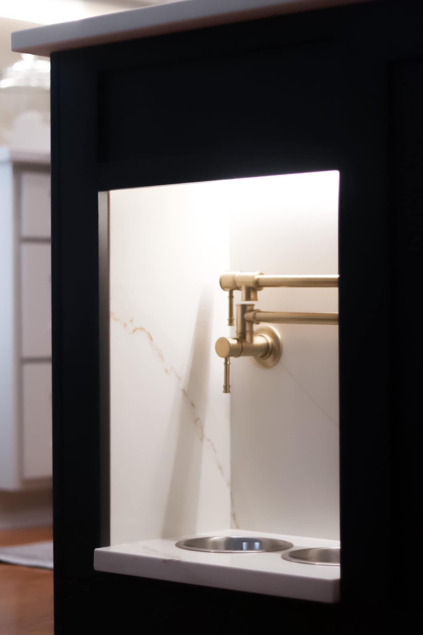 A kitchen with a sink and a faucet on the wall