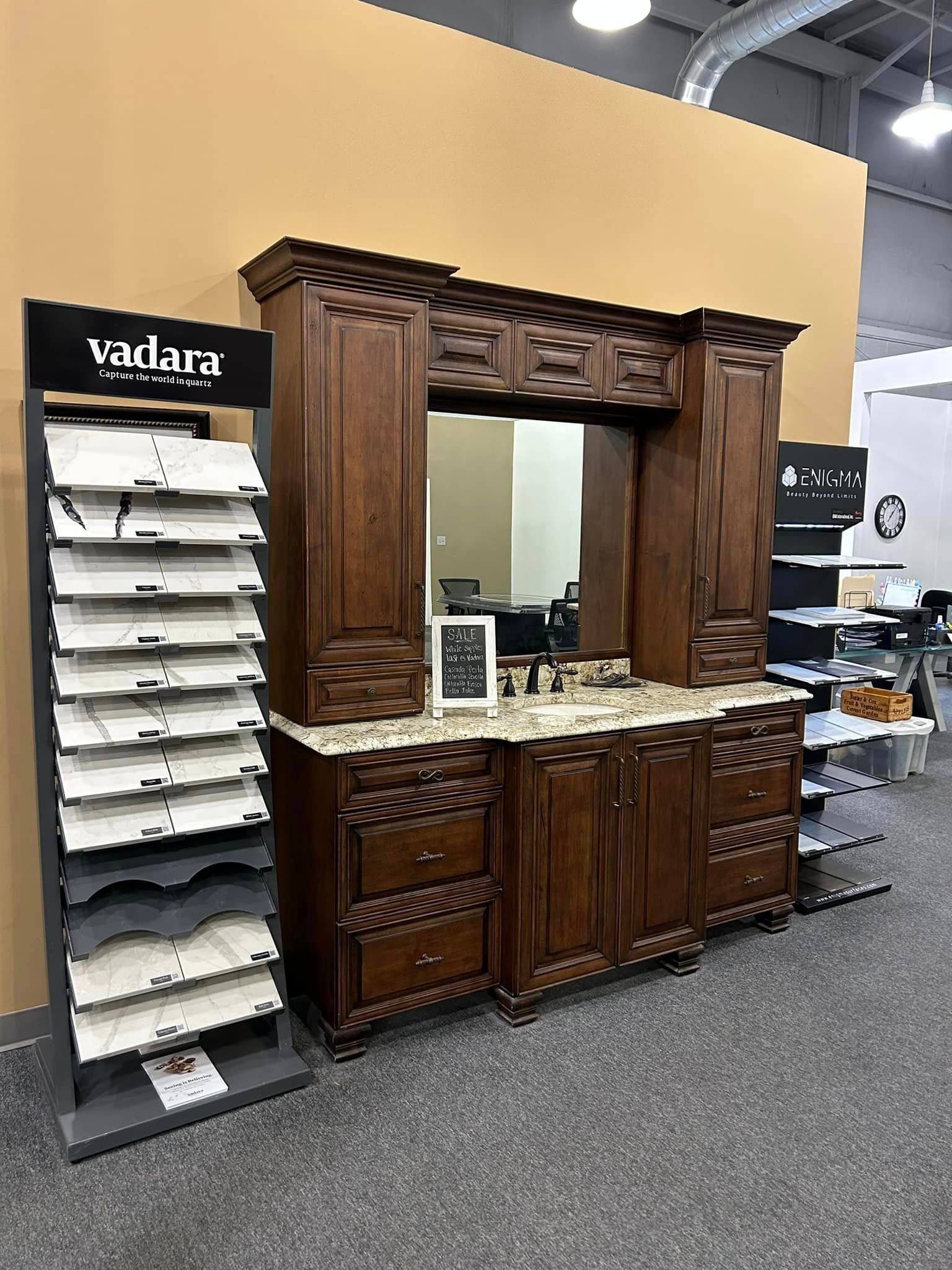 A bathroom vanity with a mirror and cabinets in a store.